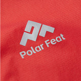 Close-up of a red fabric surface with a silver 'Polar Feat' logo.