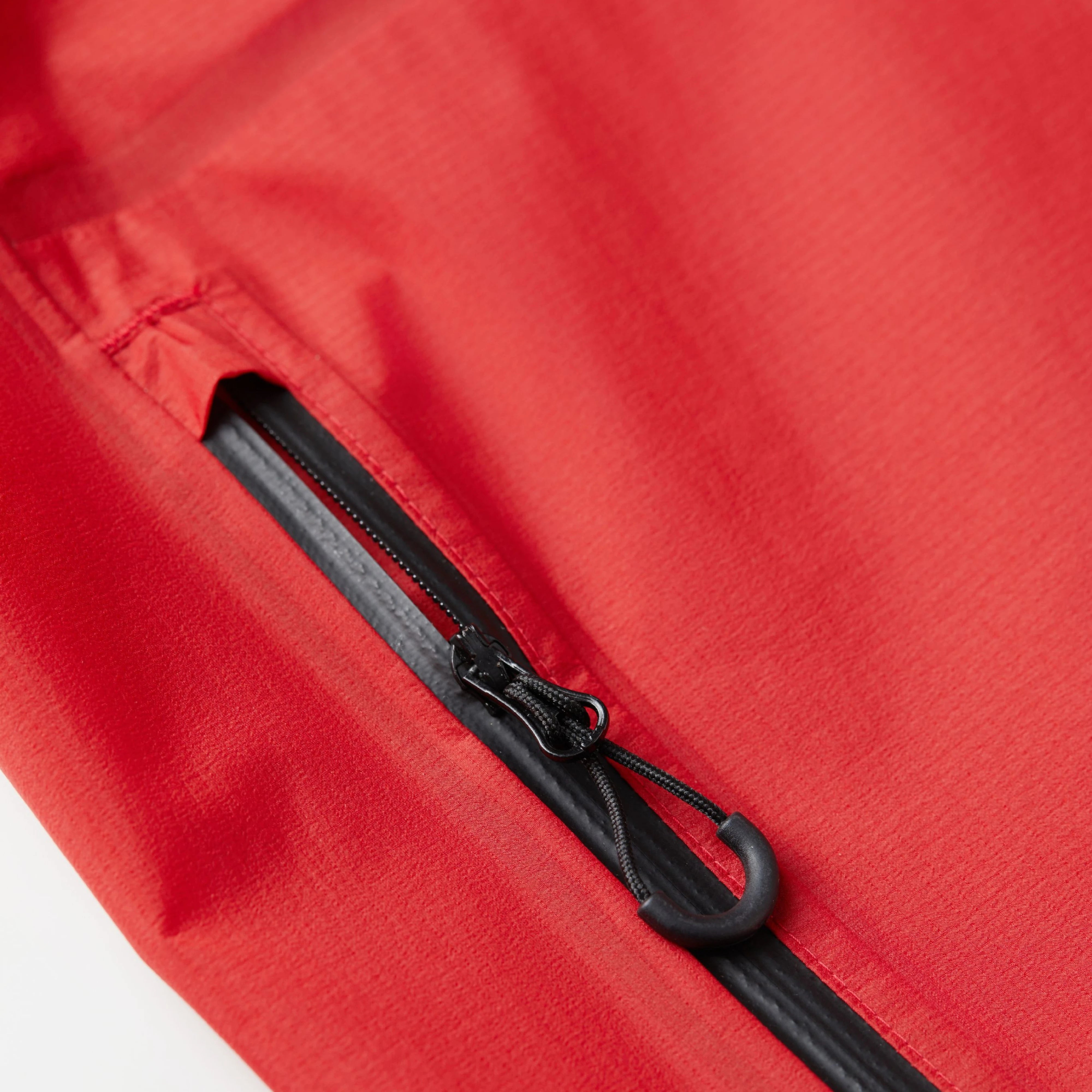 Close-up of a red jacket with a black zipper
