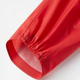 Close-up of a red fabric roll on a white background