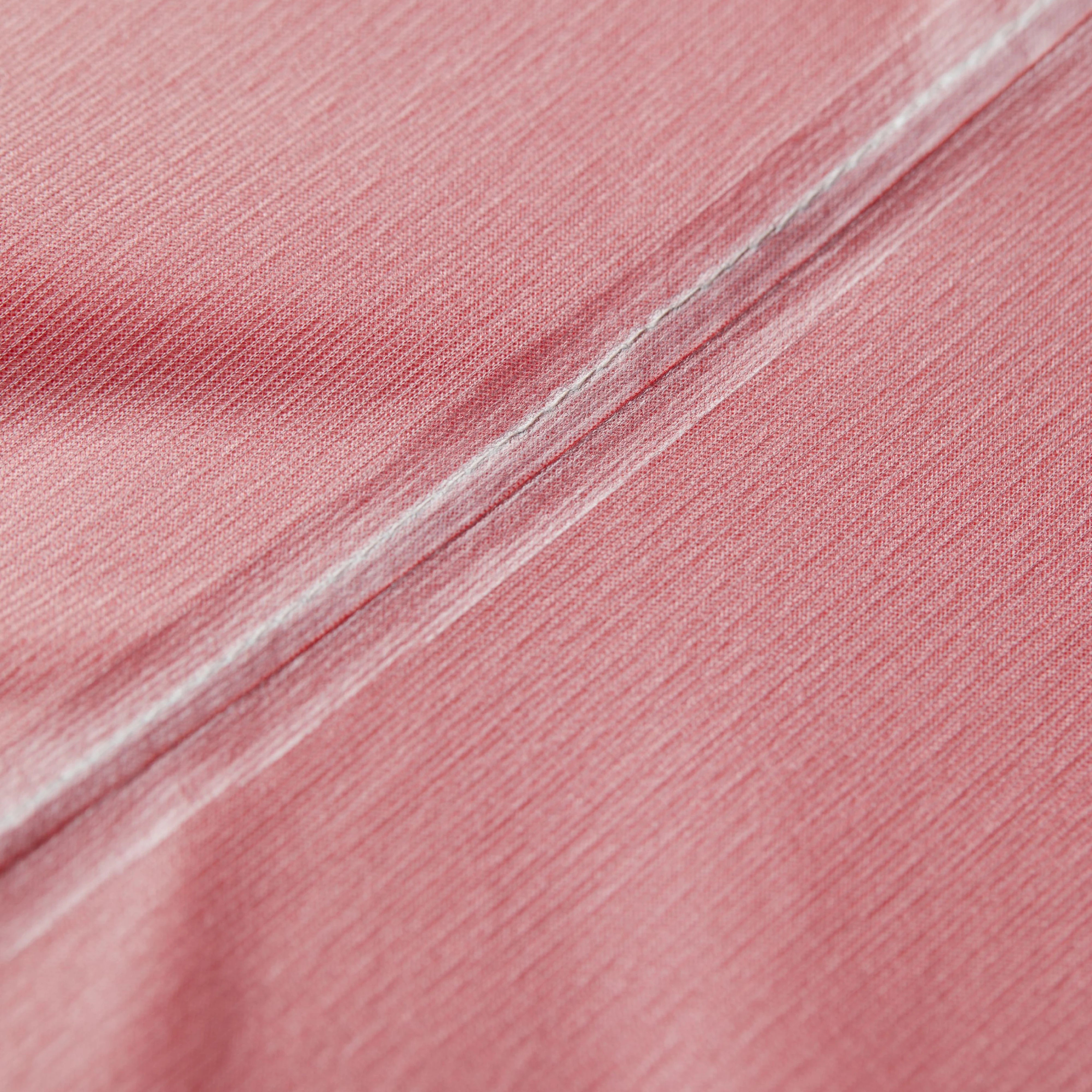 Close-up of pink fabric with a subtle texture