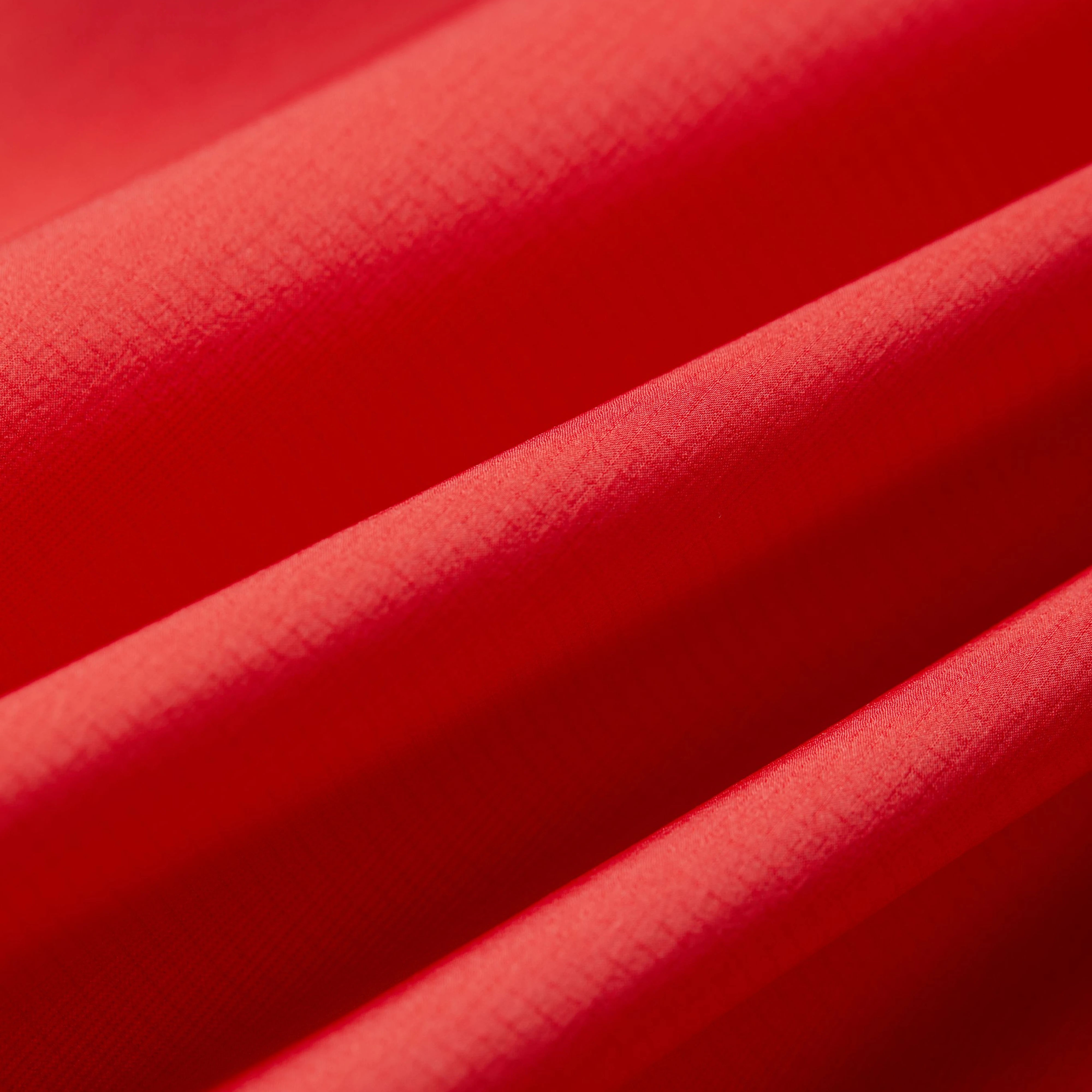 Close-up of red fabric with a textured surface