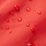Water droplets on a red textured surface